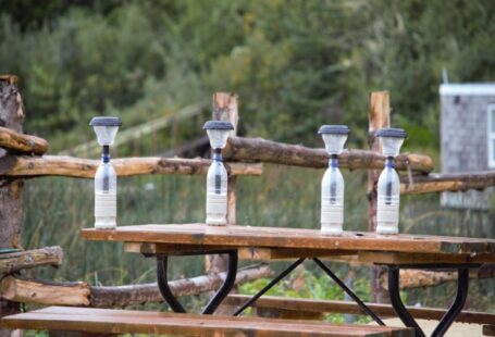 DIY Solar - four water bottles sitting on top of a picnic table