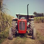 Irrigation Solar - red tractor on brown grass field during daytime