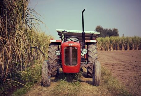 Irrigation Solar - red tractor on brown grass field during daytime