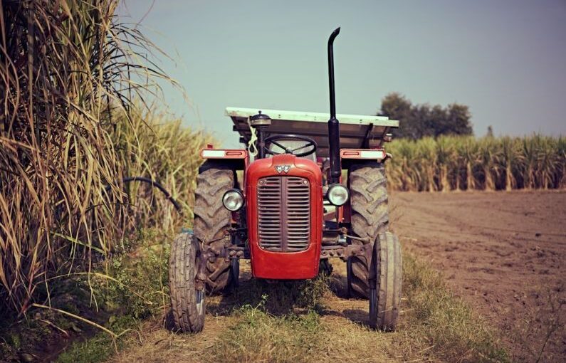 Irrigation Solar - red tractor on brown grass field during daytime