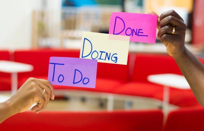 Project Management - person holding purple and white card