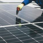 Climate Panels - a person working on a solar panel