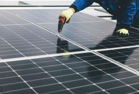 Climate Panels - a person working on a solar panel