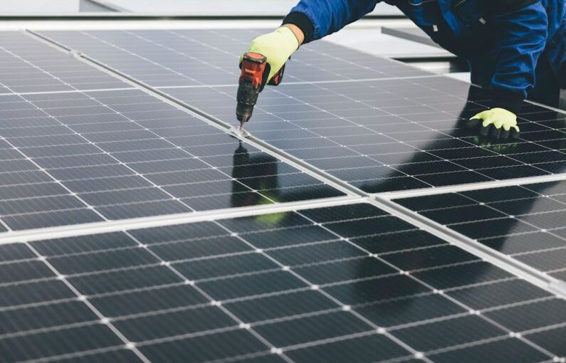 Climate Panels - a person working on a solar panel