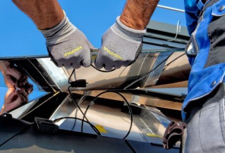 Religious Solar - two men carrying a metal sheet