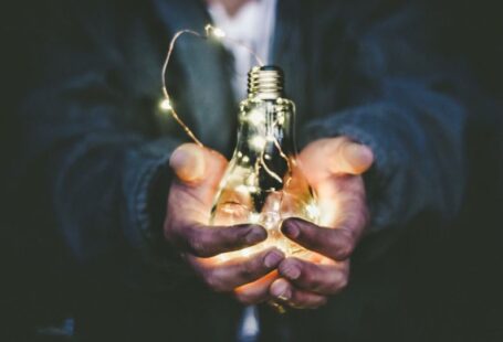 Solar Innovation - man holding incandescent bulb