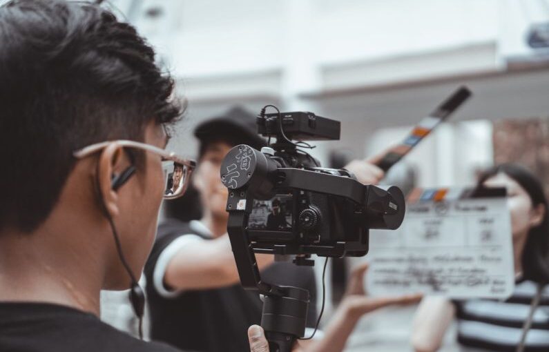 Batam Solar - man in black framed eyeglasses holding black video camera