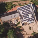 School Solar - an aerial view of a building with solar panels on the roof