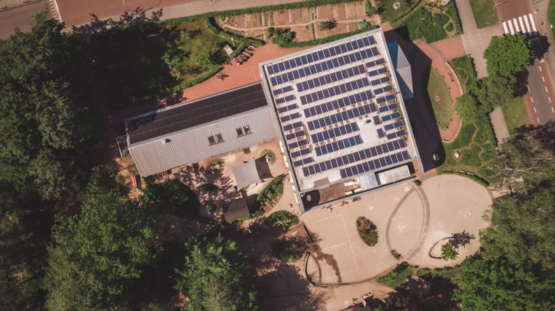 School Solar - an aerial view of a building with solar panels on the roof