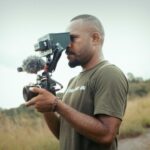 Papua Solar - a man holding a camera