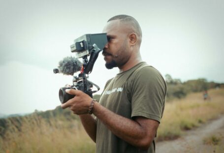 Papua Solar - a man holding a camera