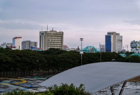 Makassar Urban - a bridge over a river with buildings in the background