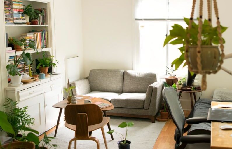 Design Solar - gray fabric loveseat near brown wooden table