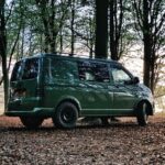 Off-grid Solar - a green van is parked in the woods