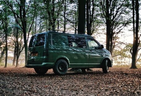 Off-grid Solar - a green van is parked in the woods