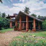 Tourism Solar - a brick house with potted plants in front of it