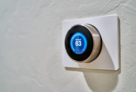 Smart Homes - gray Nest thermostat displaying at 63