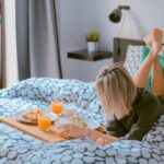 Home Tips - woman lying on bed white holding board