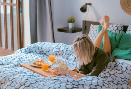 Home Tips - woman lying on bed white holding board