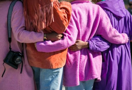 Community Solar - four person holding each others waist at daytime